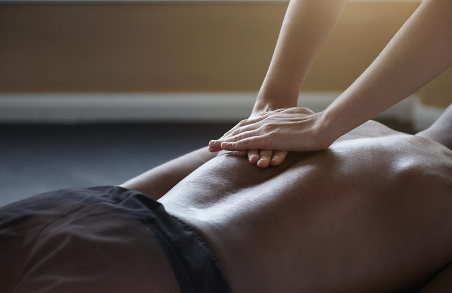 Man receiving a massage Photograph by 10000 Hours