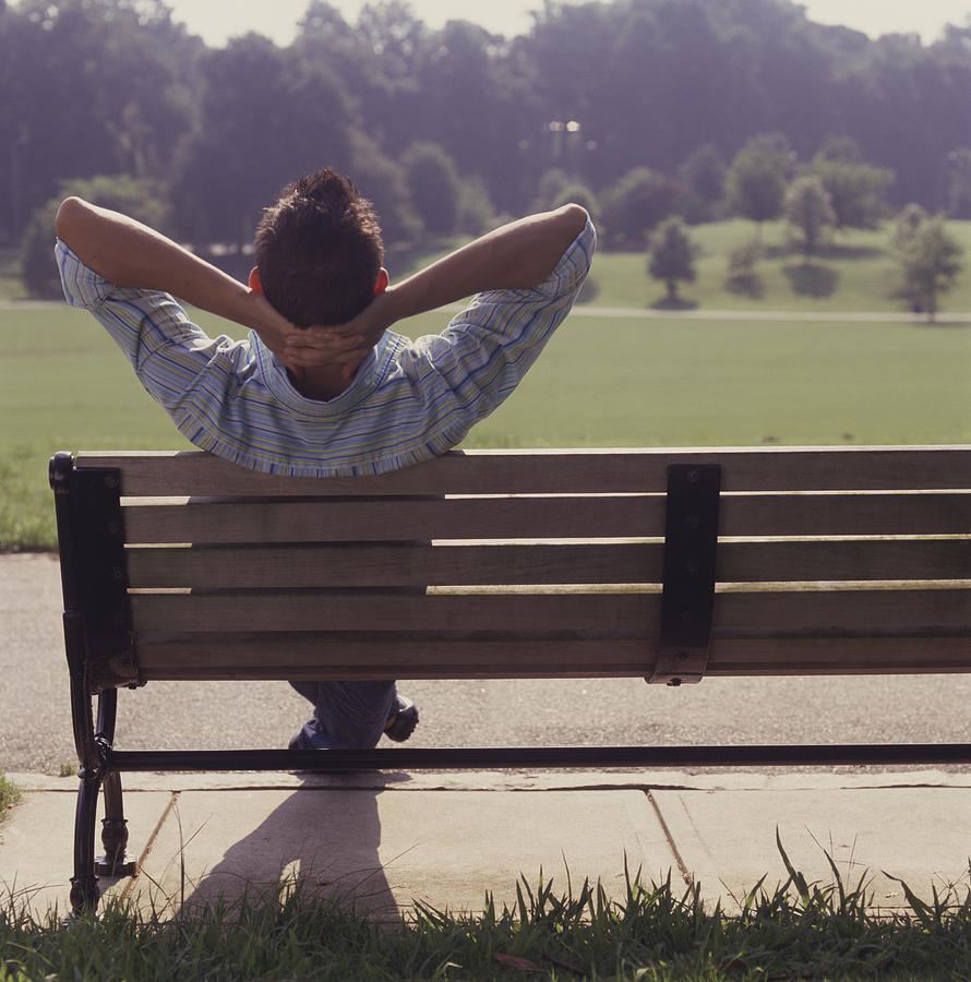 Man relaxing on park bench Photograph by Anthony-Masterson