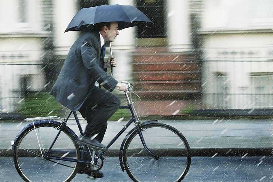 Man Riding Bicycle in Rain Photograph by Dimitri Otis
