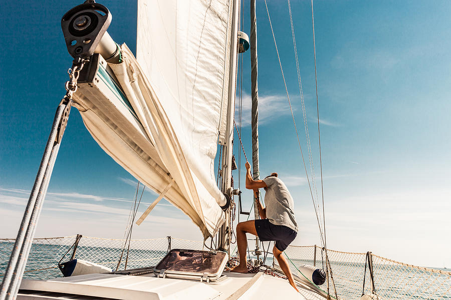 Man sailing and fishing during summer holidays Photograph by LeoPatrizi