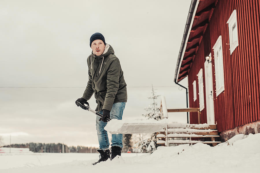 Man shoveling snow outdoors Photograph by Knape