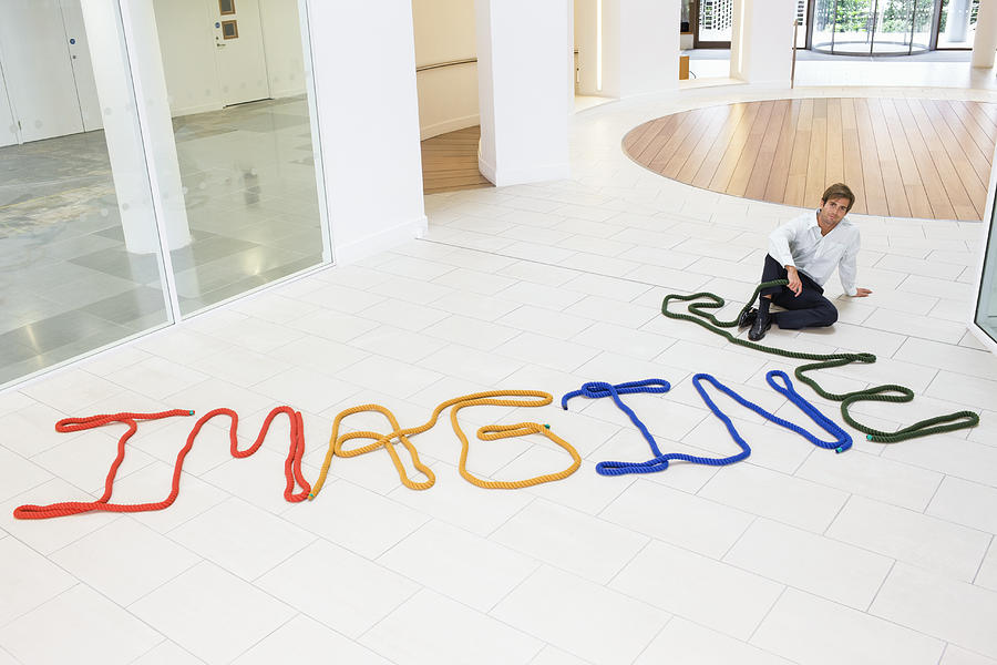 Man sitting beside the word imagine Photograph by Compassionate Eye Foundation/Justin Pumphrey/OJO Images Ltd Man sitting beside the word imagine Photograph by Compassionate Eye Foundation/Justin Pumphrey/OJO Images Ltd