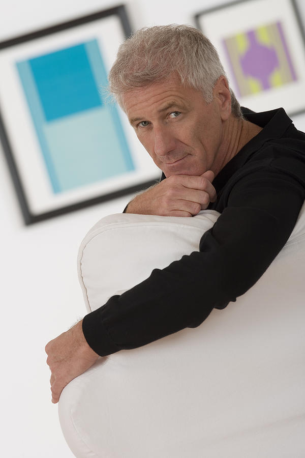 Man sitting in art gallery Photograph by Comstock Images