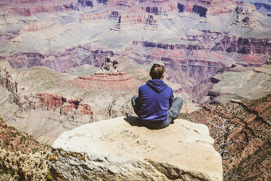 Man sitting in Grand Canyon Photograph by Alberto Zanoni
