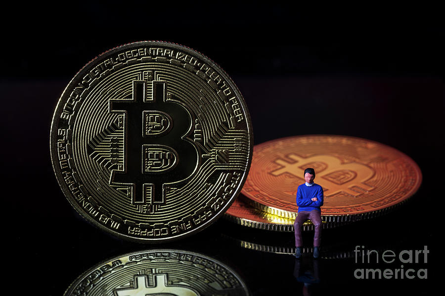 Man sitting on Bitcoin digital money crypto currency concept. Macro Photograph by Pablo Avanzini