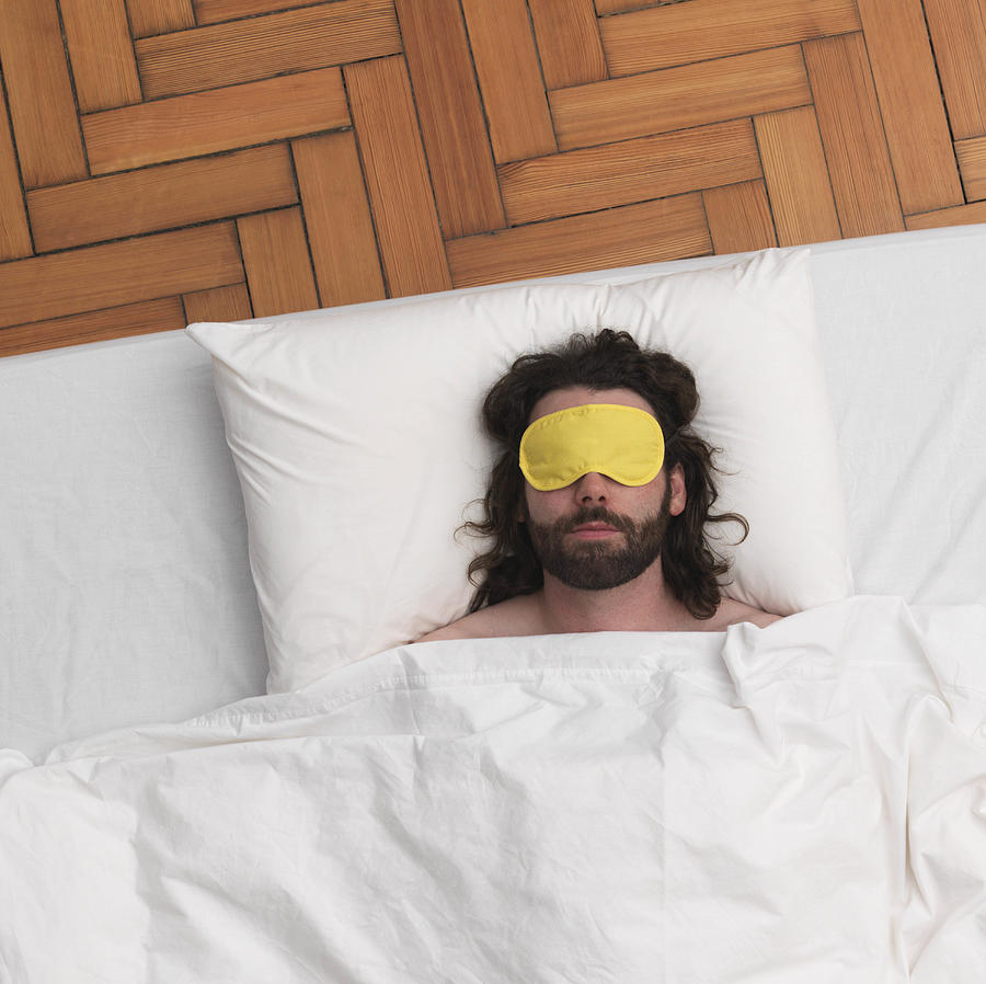 Man sleeping, wearing eye-mask Photograph by Jlph