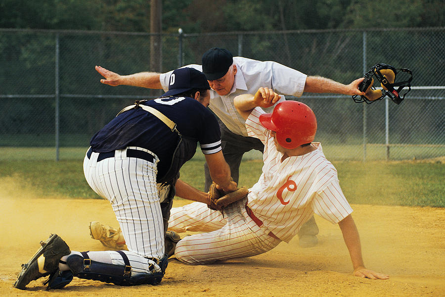 Man sliding into home plate Photograph by Comstock