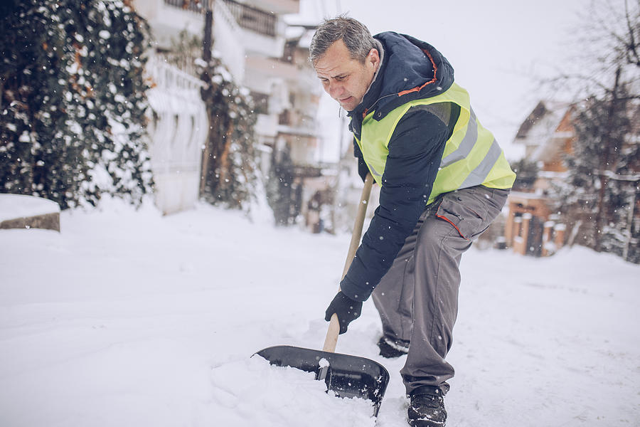 Man snow cleaning alone Photograph by South_agency