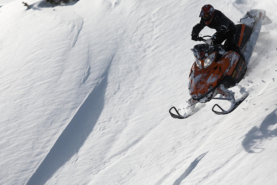 Man snowmobiling on slope, high angle view Photograph by Matt Henry Gunther