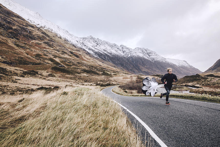 Man sprint training on a Scottish mountain road Photograph by Luca Sage