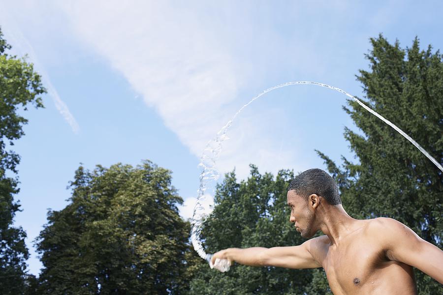 Man Squirting Water with His Hands Photograph by Oliver Rossi