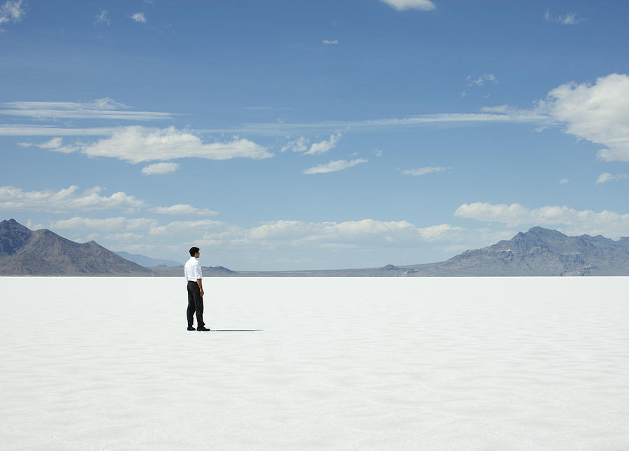 Man Standing Alone on Salt Flats. Photograph by Andy Ryan