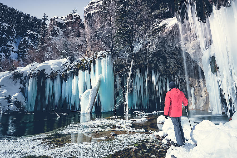 Man standing in front of frozen waterfall, Hanging lake, Colorado, America, USA Photograph by Darekm101
