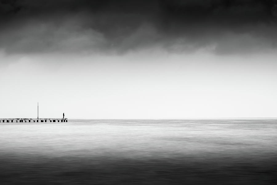 Man Standing on a Dock Staring at the Sea in Black and White Photograph by Alexios Ntounas