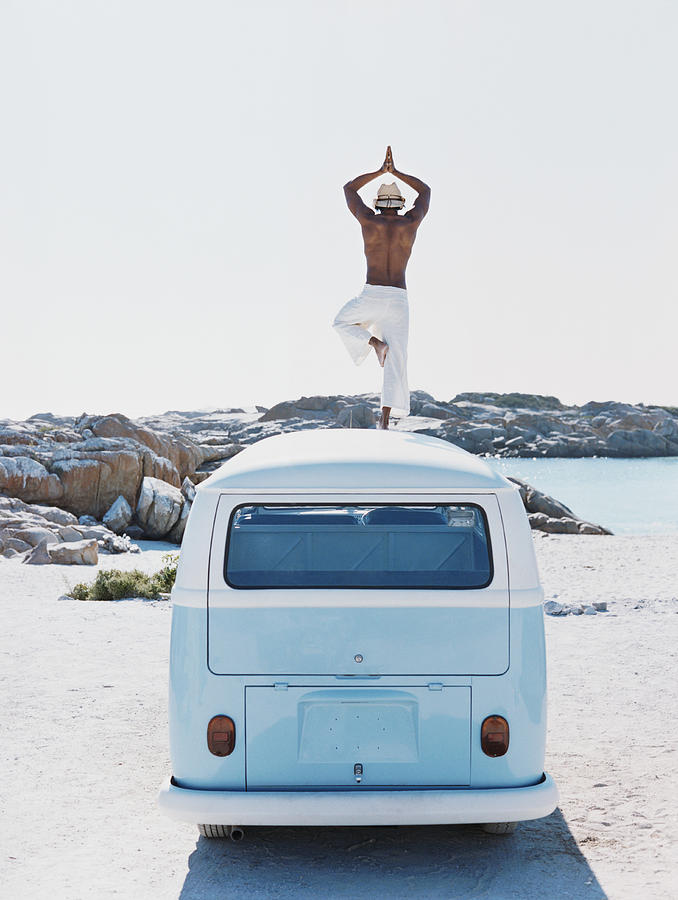 man Standing on the Roof of a Camping Van Practising Yoga Photograph by BJ Formento