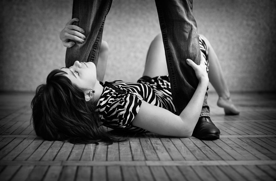 Man Standing Over a Young Woman Lying on Floor Photograph by _ib_