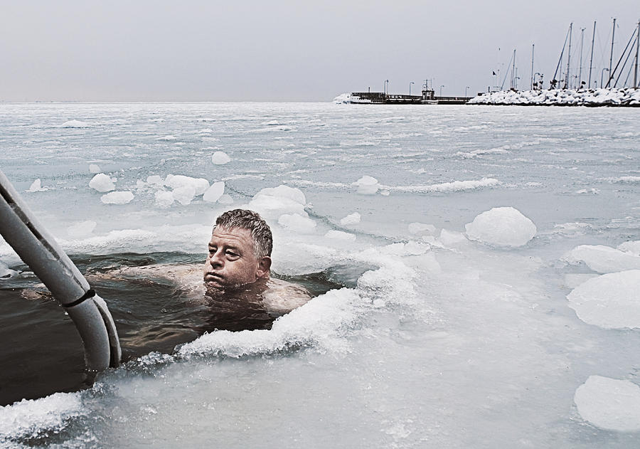 Man submerged in frozen sea. Photograph by David Trood