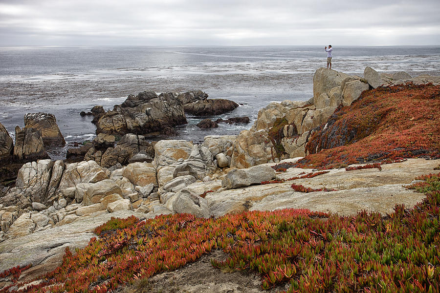 Man taking a photo on the coastline of 17 Mile Drive near Monterey, California Photograph by Mark Meredith