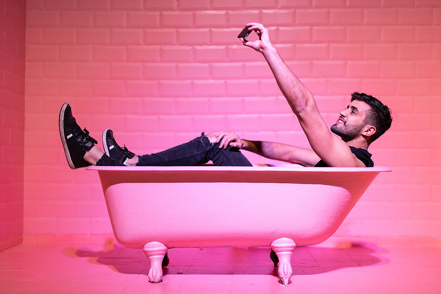 Man Taking a Selfie in the pink bathtube Photograph by FG Trade