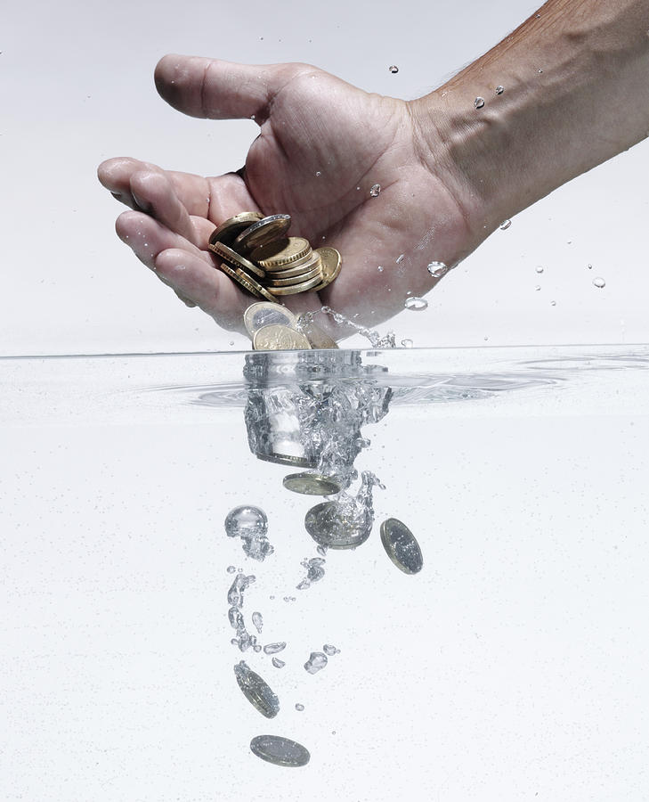 Man throwing money in water Photograph by Buena Vista Images