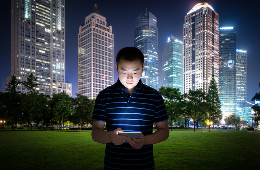 Man Using a Digital Tablet Photograph by Yongyuan Dai