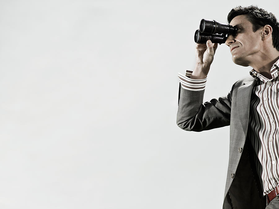 Man using binoculars Photograph by Image Source