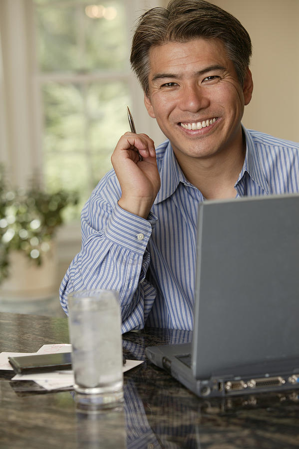 Man using laptop Photograph by Comstock Images
