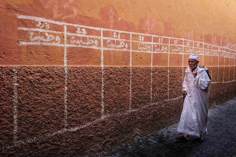 Man walking at Marrakech medina Photograph by Ruben Vicente