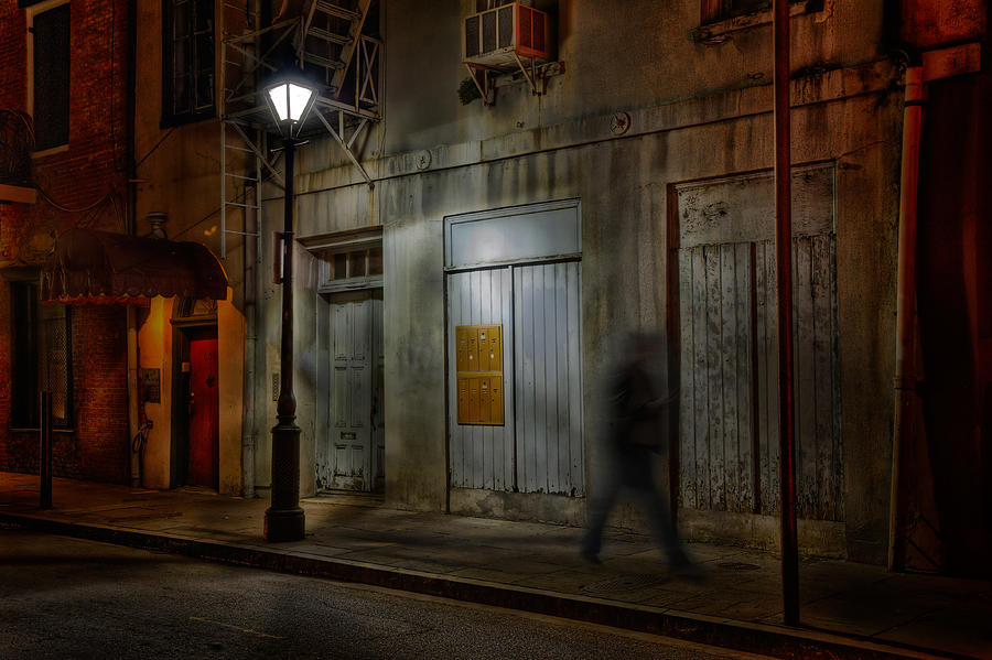 Man walking on sidewalk at night, French Quarter, New Orleans, USA Photograph by Diana Robinson