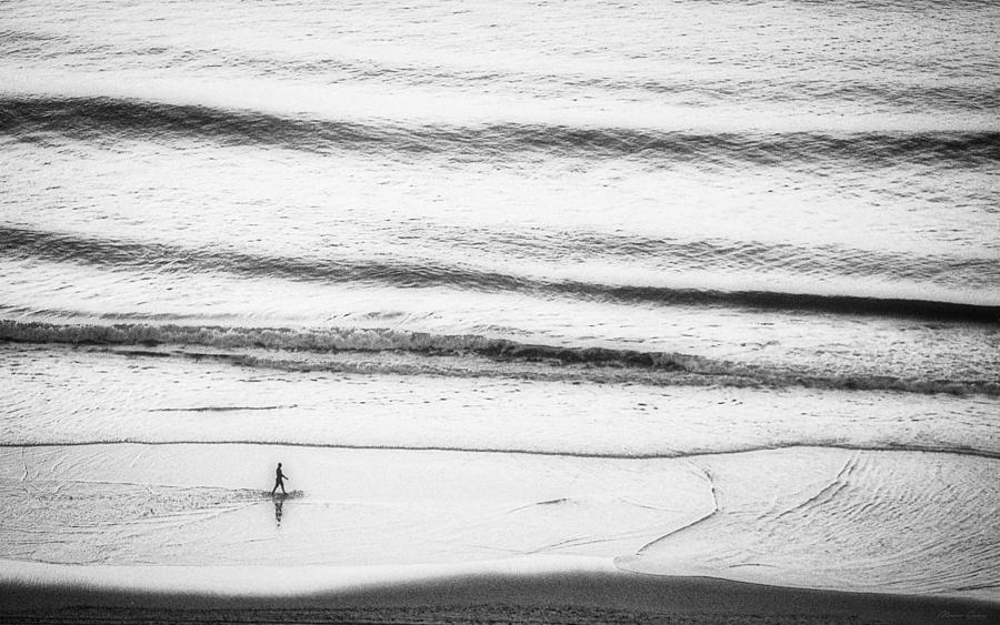 Man Walking on the Beach shoreline BW Photograph by Marco Sales