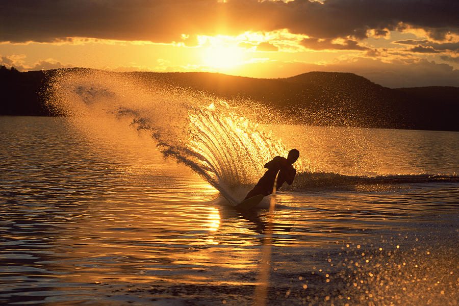 Man waterskiing at dusk Photograph by Comstock Images