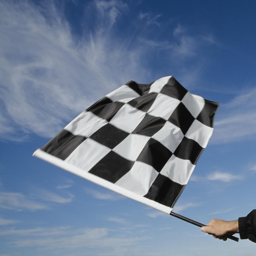 Man waving checkered flag (blurred motion) Photograph by David Madison