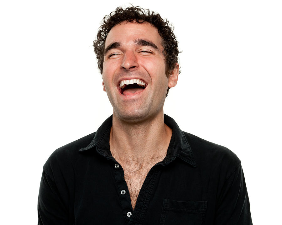 Man wearing black shirt laughing with eyes shut Photograph by Drbimages