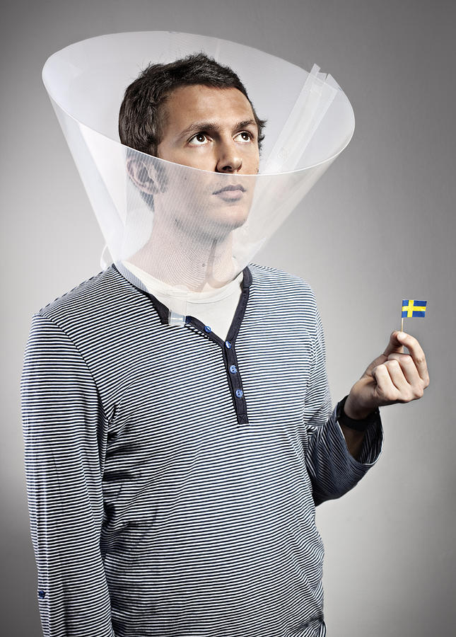 Man Wearing Dog Cone Holding Mini Swedish Flag Photograph by Orbon Alija