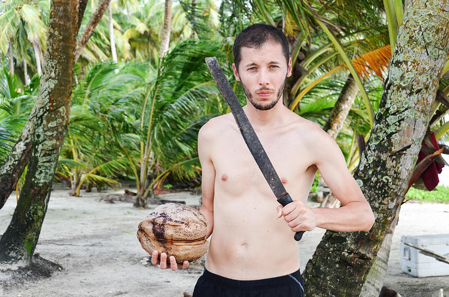 Man with a machete and a coconut Photograph by Volanthevist