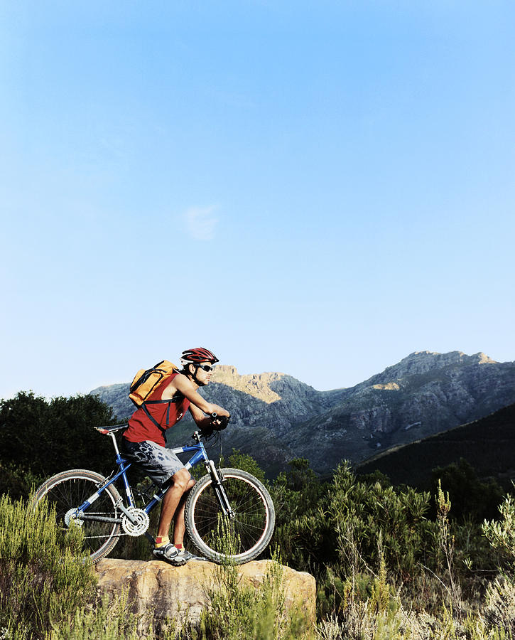 Man With a Mountain Bike Out in the Wilderness Photograph by Digital Vision.