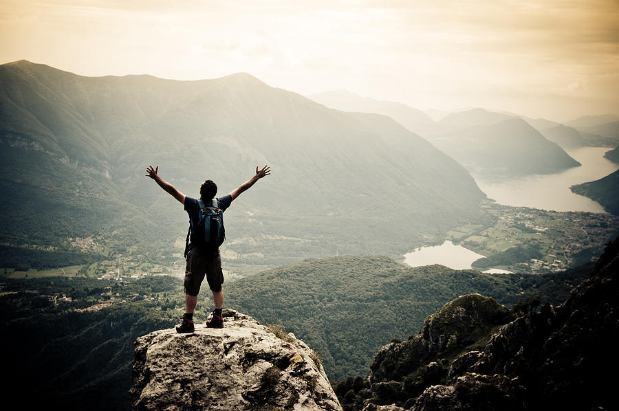 Man with arms outstretched on mountaintop Photograph by Mmac72