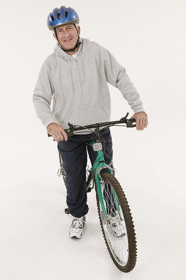 Man with bike Photograph by Comstock Images