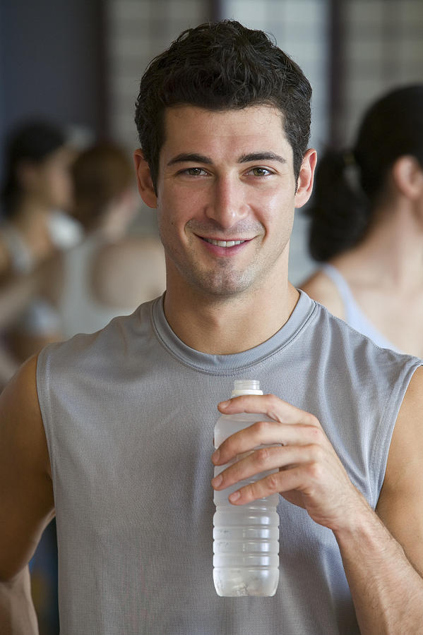 Man with bottled water Photograph by Comstock Images