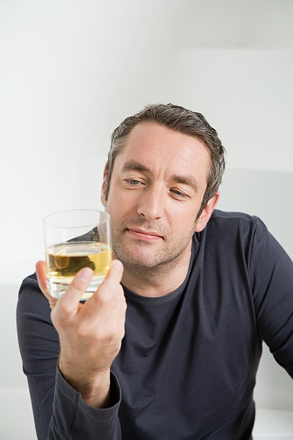 Man with glass of whisky Photograph by Image Source
