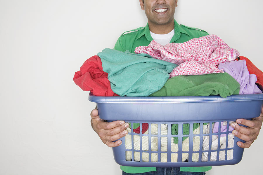 Man with laundry basket Photograph by Verity Jane Smith