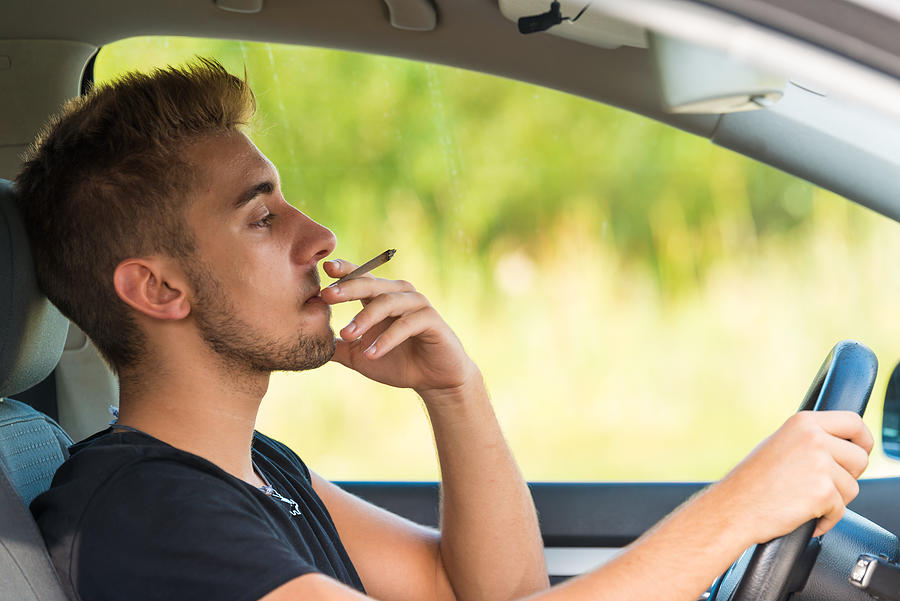Man with marijuana in car Photograph by GregorBister