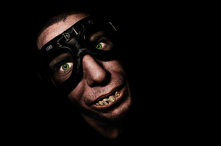 Man with motorcycle goggles or glasses, with funny fake teeth, smiling Photograph by Photo by Jeff Krol