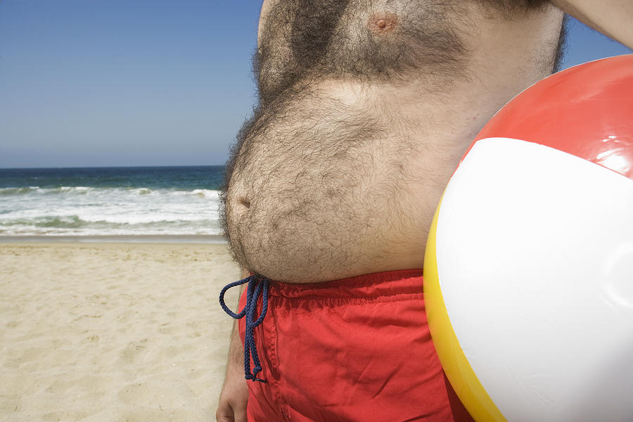 Man with pot belly at the beach Photograph by Sian Kennedy
