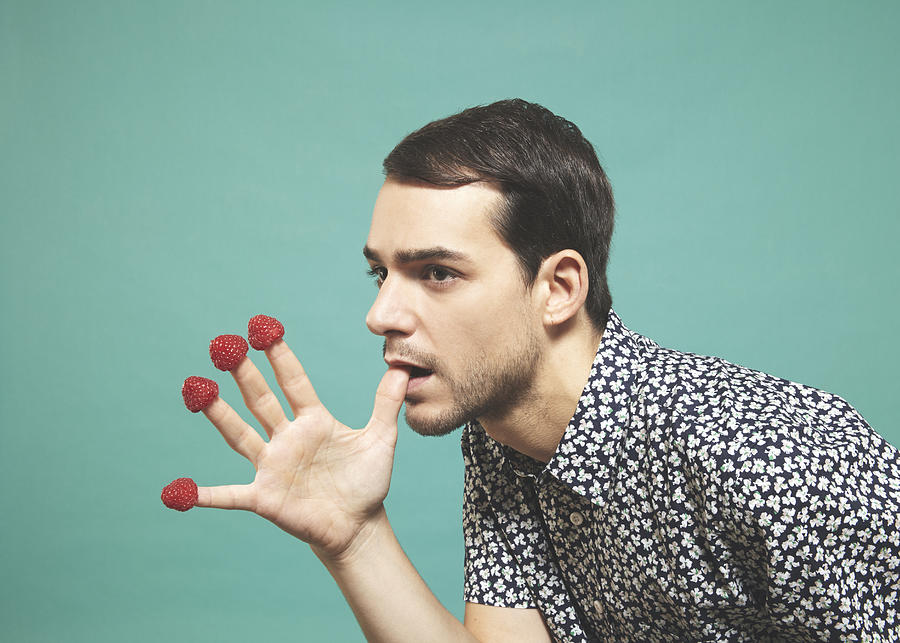Man with raspberries  on finger tips Photograph by Alma Haser