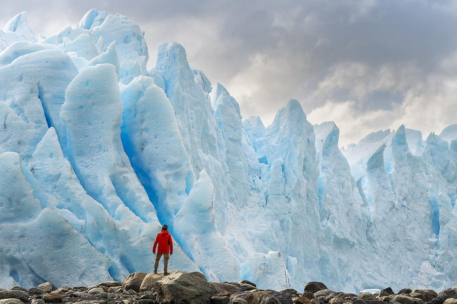 Man with red jacket standing in front of the snout of Perito Moreno glacier, El Calafate, Santa Cruz province, Argentina. Photograph by Francesco Vaninetti Photo