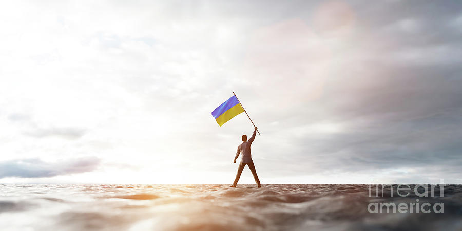 Man with Ukraine flag on abandoned wasteland. Photograph by Michal Bednarek