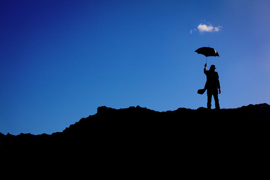 Umbrella Photograph - Man With Umbrella And Single Lonely Cloud by Garry Gay