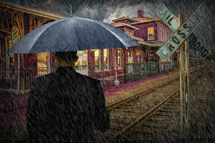 Man with Umbrella in the Rain at an Old Train Station Photograph by Randall Nyhof