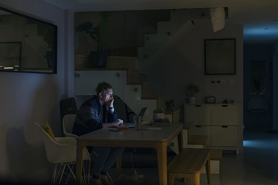Man working from home late at night Photograph by Justin Paget